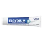 Tub alb cu bandă albastră de pastă de dinți Elgydium Blancheur Whitening, culcat pe fundal alb