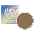 Cutia timeBalm și cutiuța deschisă cu fond de ten cremă, nuanța After Dark