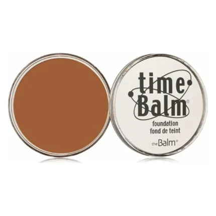 Borcănel deschis cu fond de ten The Balm timeBalm nuanța Dark, lângă capacul alb